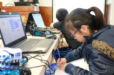 Students at the Youth Robotics Summer Camp working with laptops