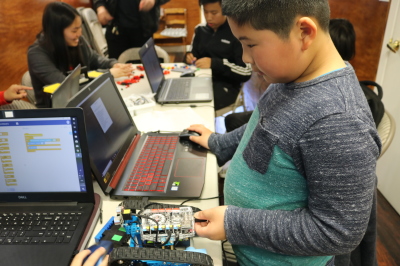 Camp participants programming a robotics exercise